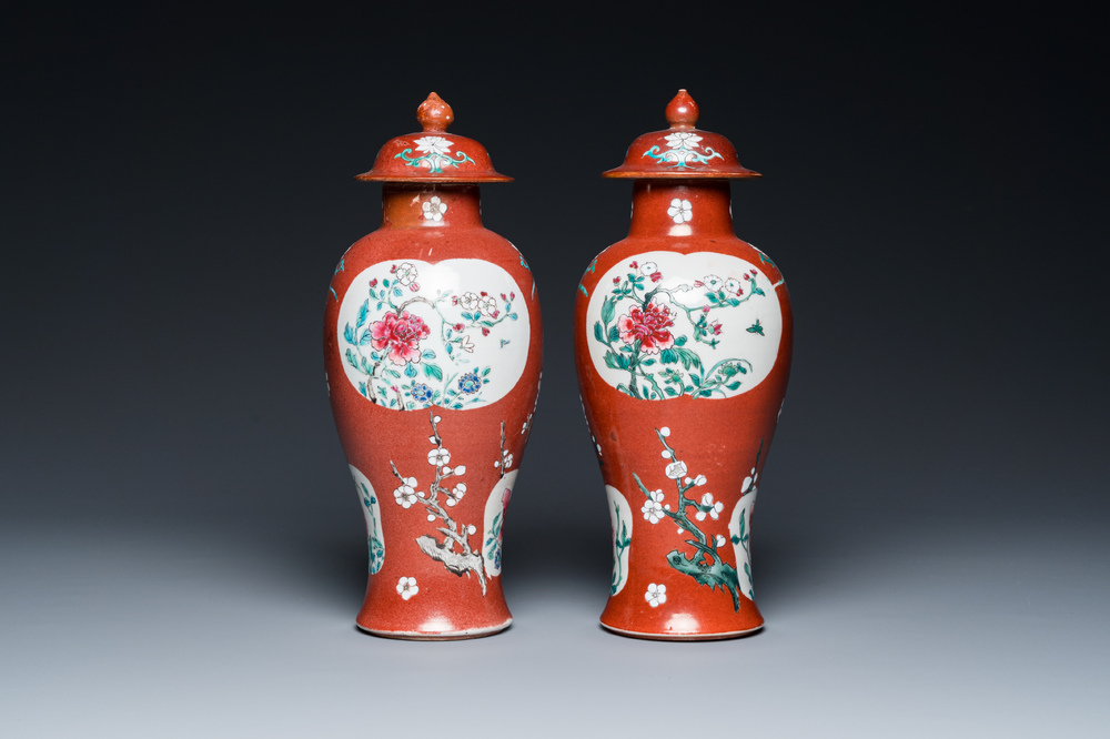 A pair of Chinese famille rose ruby-ground vases and covers, Yongzheng/Qianlong