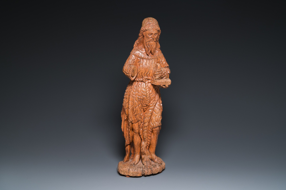 A large carved oak sculpture of John the Baptist holding the Lamb, 16th C.