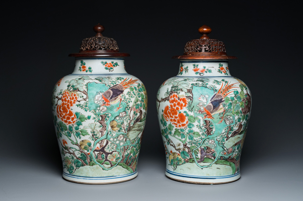 A pair of Chinese famille verte 'pheasant' vases with wooden covers, Kangxi