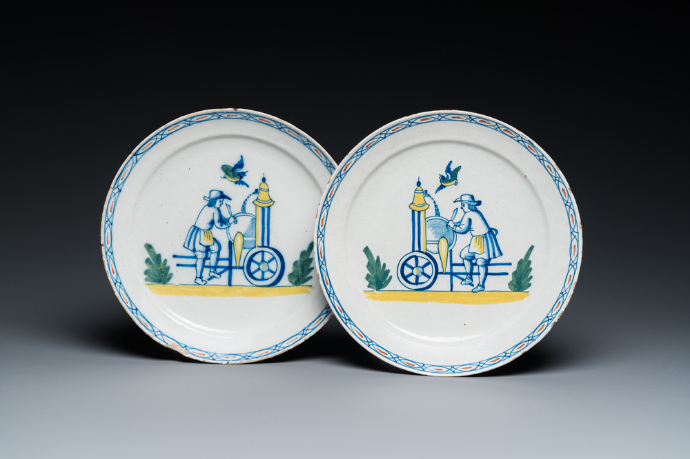 A pair of polychrome Dutch Delft plates depicting grinders, 18th C.