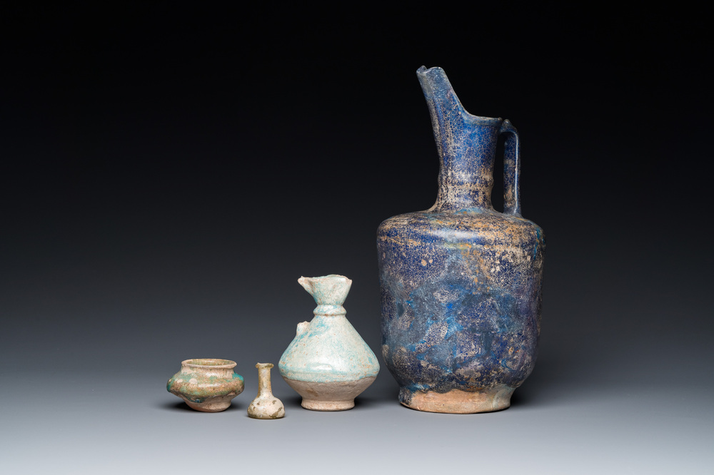 Three blue- and turquoise-glazed Islamic pottery wares and a glass bottle, Kashan and Raqqa, 12th C. and later