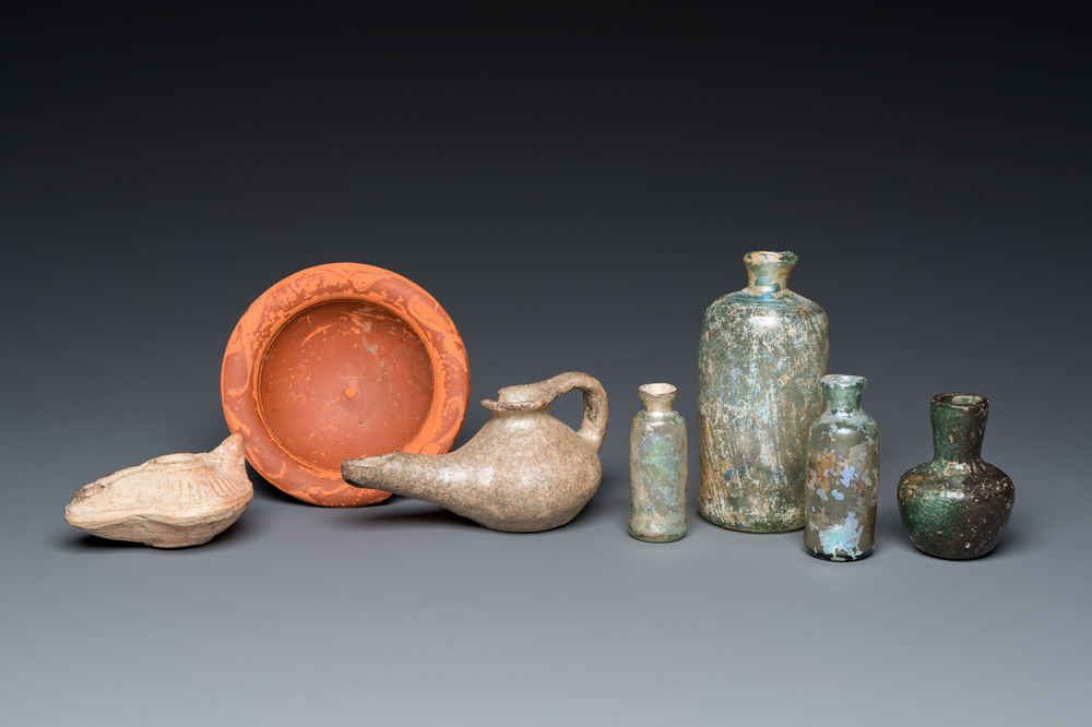 Four Roman glass bottles, two pottery oil lamps and a bowl