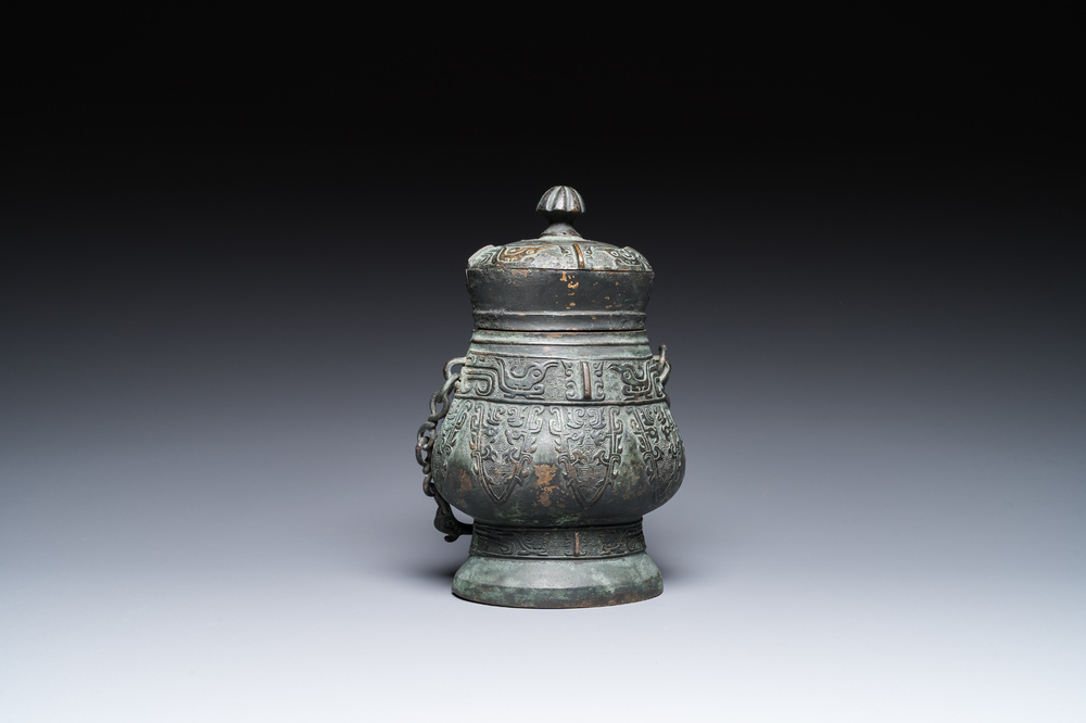 A Chinese archaic bronze ritual 'you' wine vessel and cover in Western Zhou-style, Ming