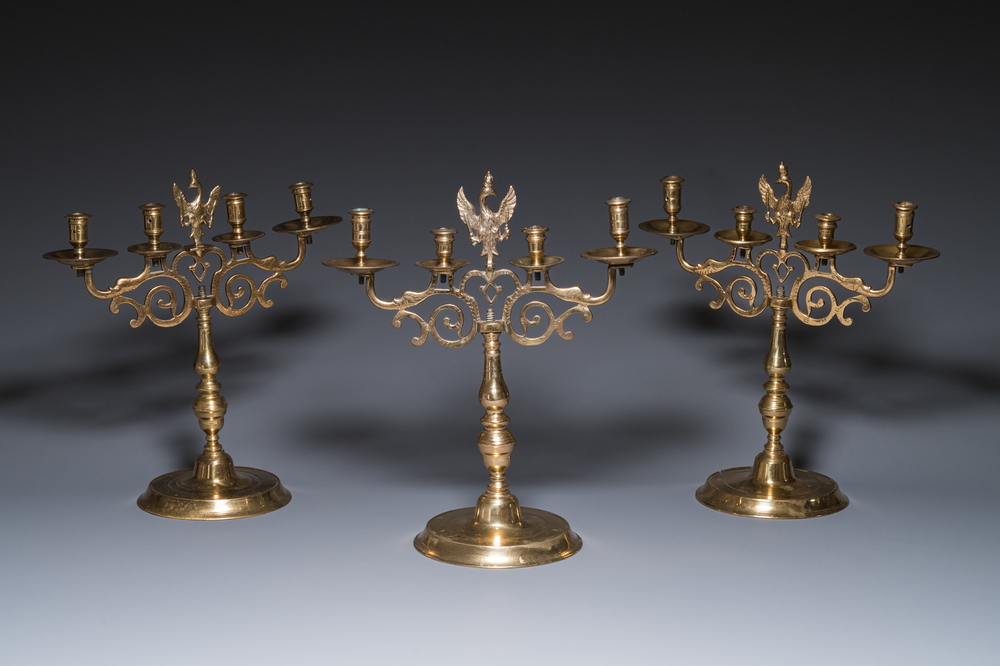 Three large Polish or Prussian bronze 'shabbat' candlesticks crowned with double eagles, 17th C.