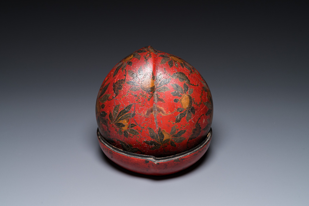 Een Chinese perzikvormige dekseldoos in beschilderd lakwerk, Qing