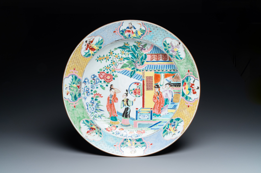 A large Chinese famille rose dish with a temple scene and eight immortals on the rim, Yongzheng