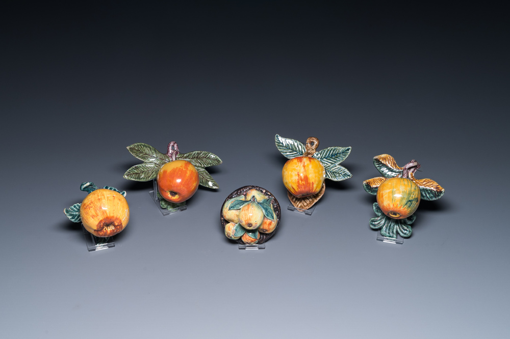 Four polychrome Dutch Delft hanging models of apples and a rare table piece with apples and pears, 18th C.