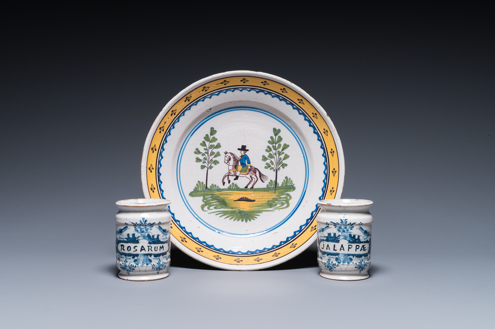 Two Dutch Delft blue and white drug jars and a polychrome Brussels faience dish with a rider on horseback, 18th C.