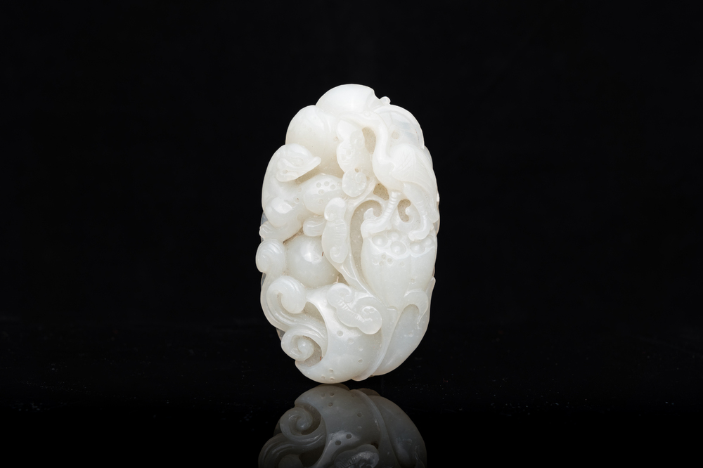 A Chinese white jade paper weight with a crane and a tiger, 17/18th C.