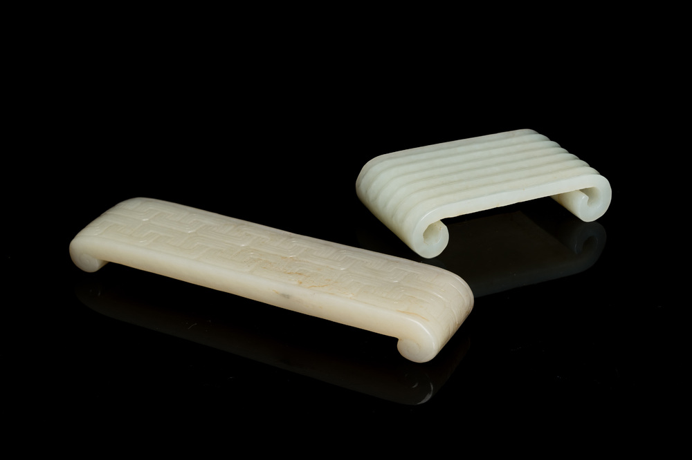 Two fine Chinese white and celadon jade brush rests, Qing