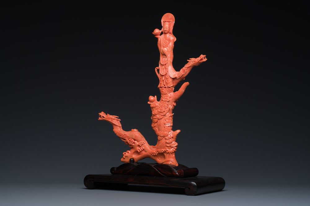 A Chinese red coral figure of a standing Bodhisattva with two dragons, 19/20th C.