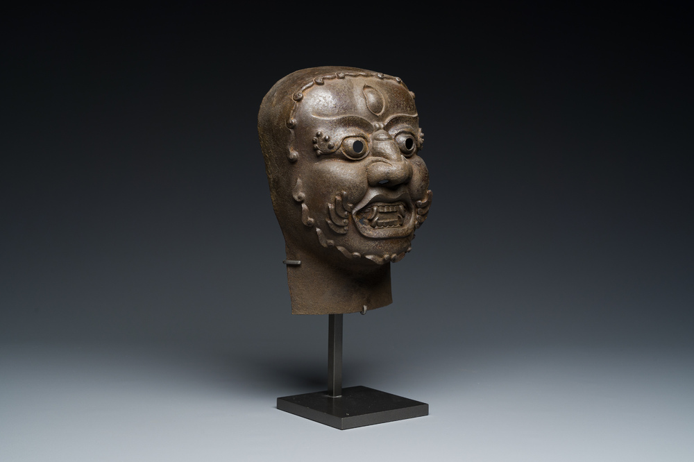 A Tibetan cast iron 'Mahakala' mask, 16/17th C.