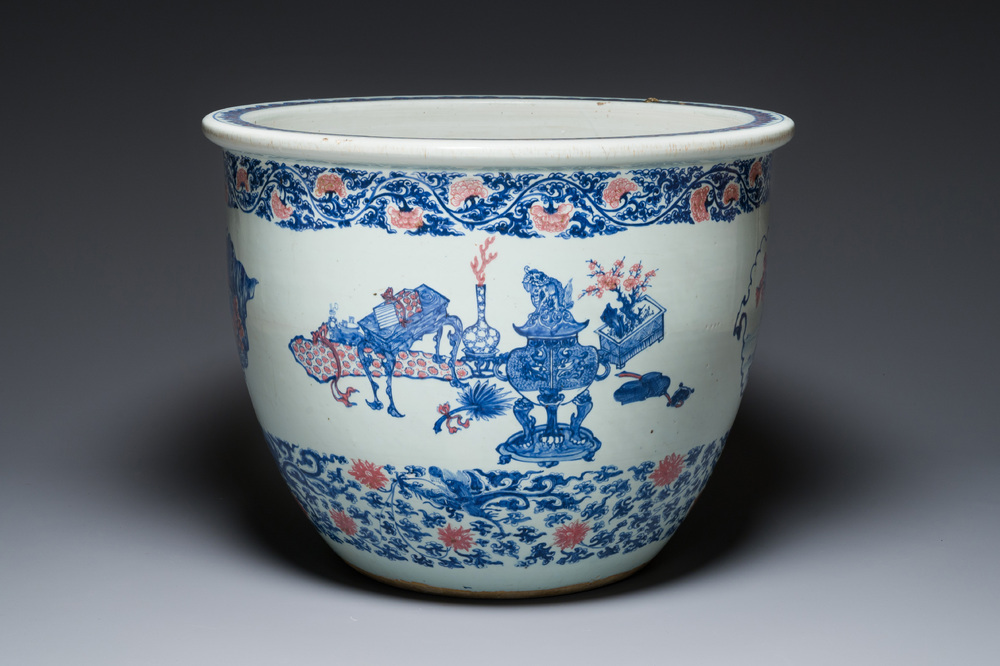 An exceptional massive Chinese blue, white and copper-red fish bowl with antiquities and 'Master of the rocks'-style panels, Kangxi