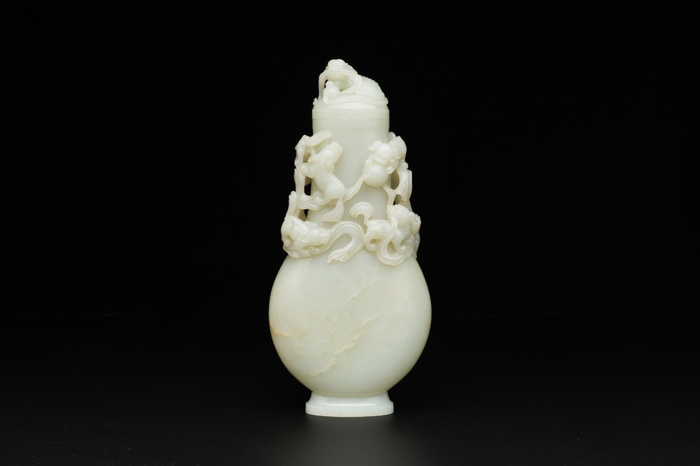 A fine Chinese white jade 'buddhist lions' vase and cover, Qing