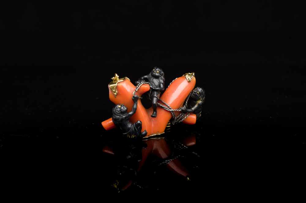 A rare Japanese gold and silver pendant with three South Sea-islanders on a coral branch, Meiji, 19th C.