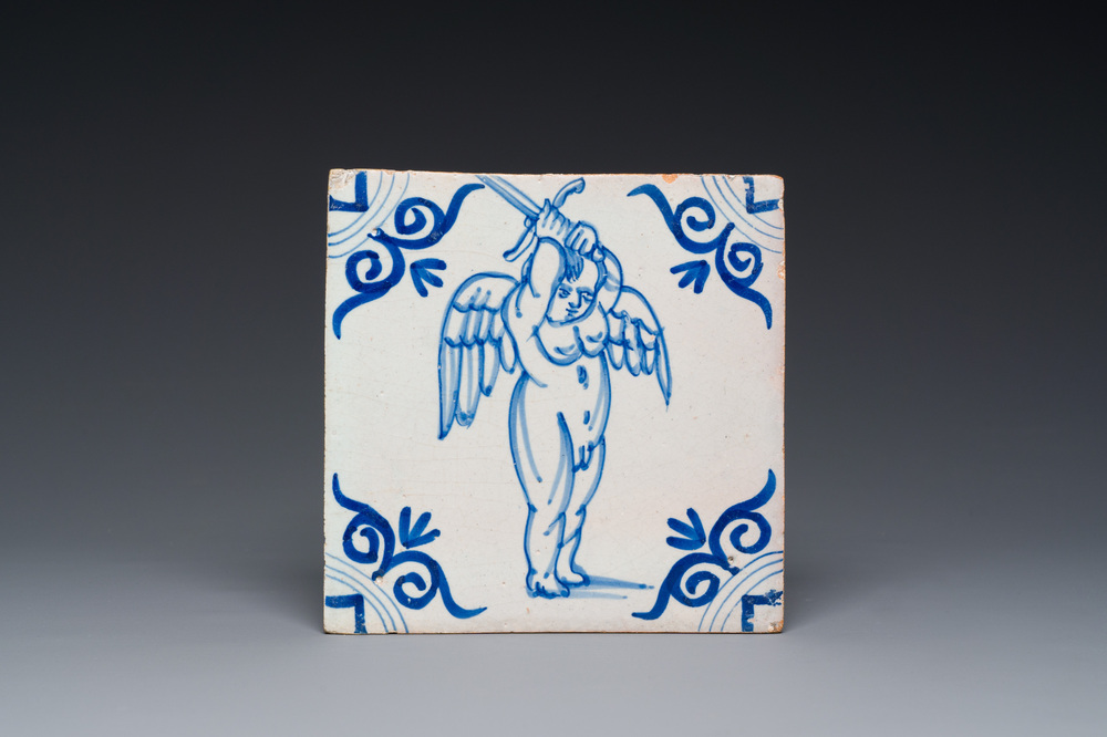 A rare Dutch Delft blue and white tile with a large cherub holding a sword, 1st half 17th C.