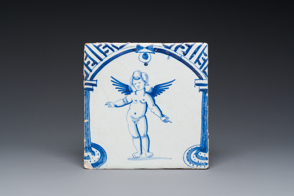 A rare Dutch Delft blue and white tile with a large cherub below a gate, 1st half 17th C.