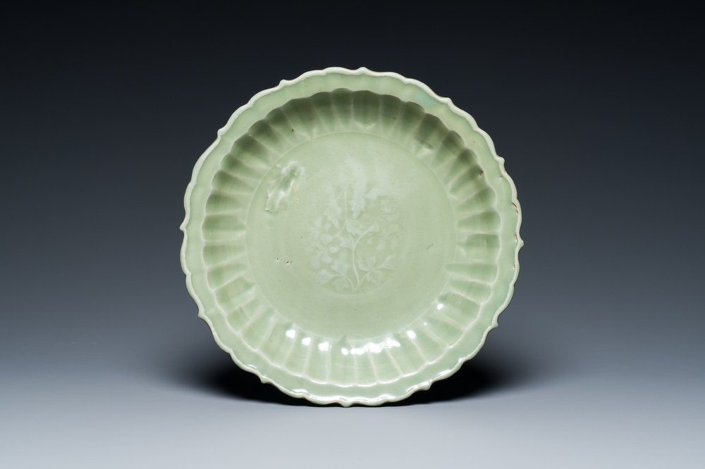 A Chinese Longquan celadon lotus-form dish with underglaze floral design, Ming