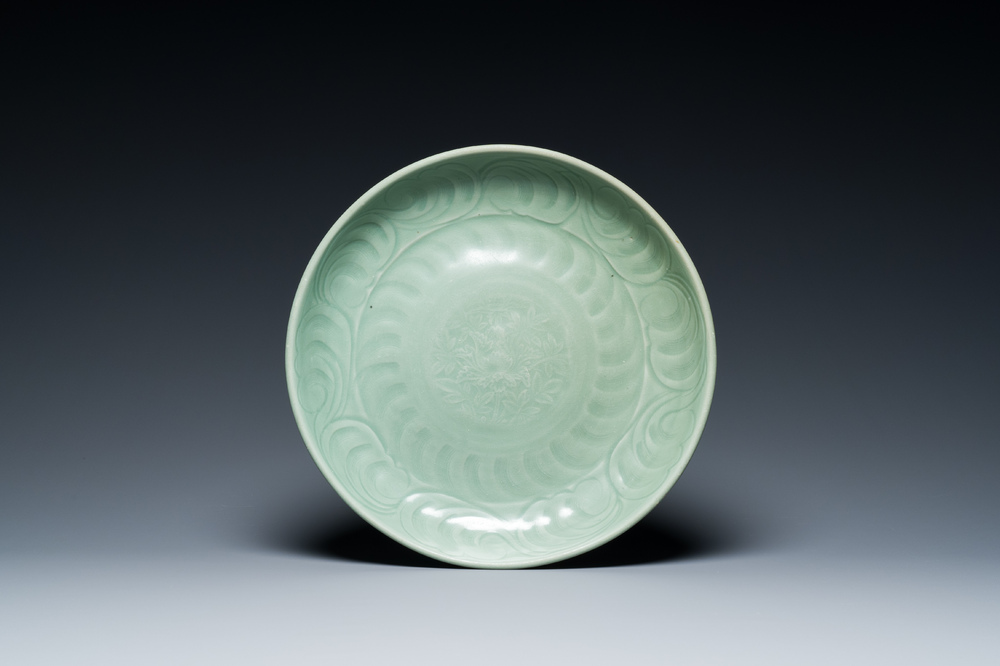 A Chinese Longquan celadon dish with underglaze floral design, Ming