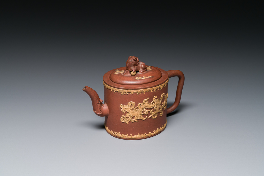 A Chinese Yixing stoneware teapot and cover with an applied dragon, Kangxi