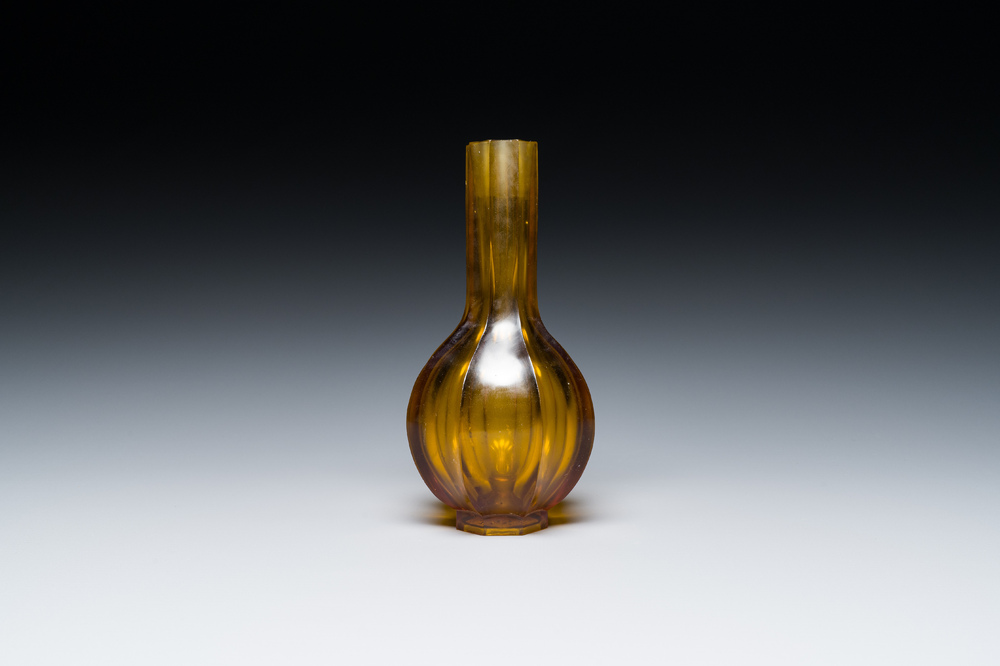 A Chinese facetted translucent green-coloured Peking glass bottle vase, Qianlong mark, 19th C.