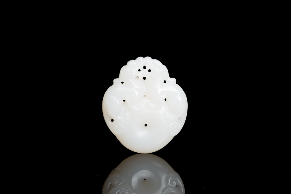 A Chinese white jade 'mythical beasts' pendant, Qing