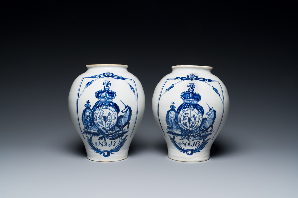 A pair of Dutch Delft blue and white tobacco jars with the royal British coat of arms, late 18th C.