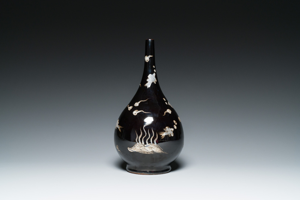 A Chinese black-glazed reverse-decorated bottle vase, 19th C.