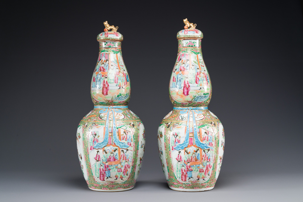A pair of Chinese Canton famille rose double gourd vases and covers, 19th C.