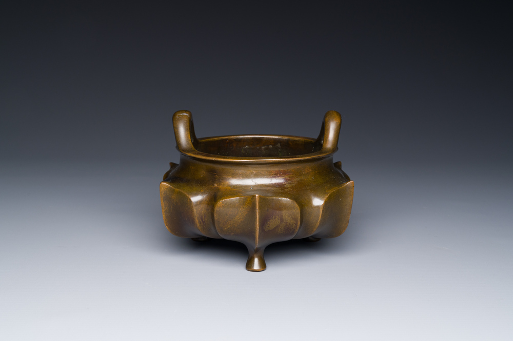 A Chinese bronze lotus-shaped tripod censer, Xuande mark, 18/19th C.