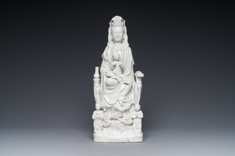 A Chinese Dehua blanc de Chine group of Guanyin with a child and servants, 18th C.