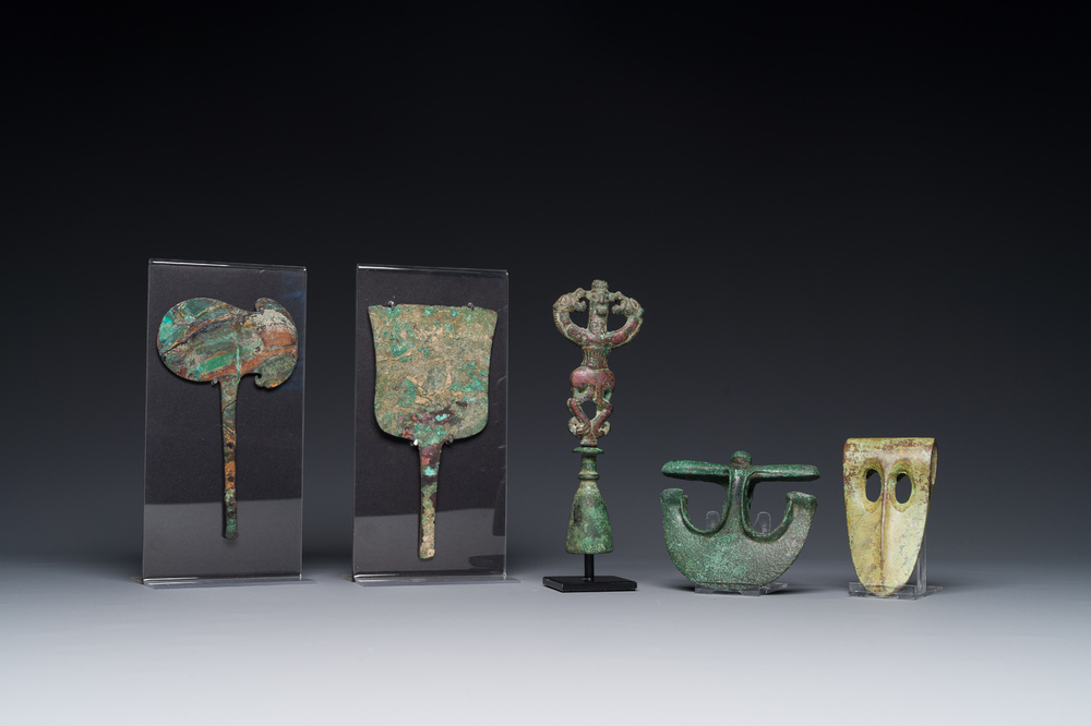 A collection of three bronze axes, a mirror and an anthropomorphic idol with two dragon heads, Luristan, 2000 B.C and earlier