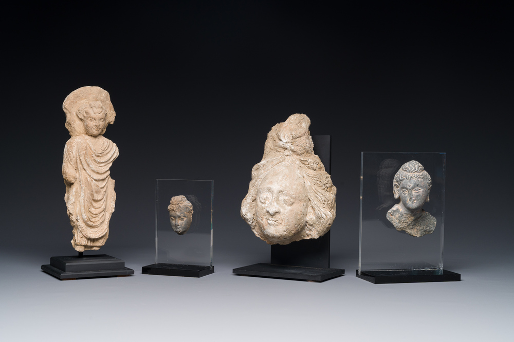 Two small Gandhara grey schist Bodhisattva heads, a stucco sculpture of Bodhisattva and a stucco female head, 1/4th C.