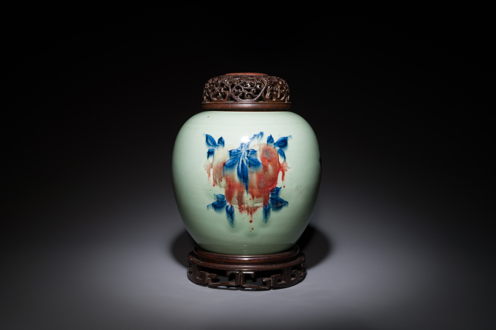 A Chinese celadon-ground blue, white and copper-red ginger jar with reticulated wooden cover and stand, 18th C.