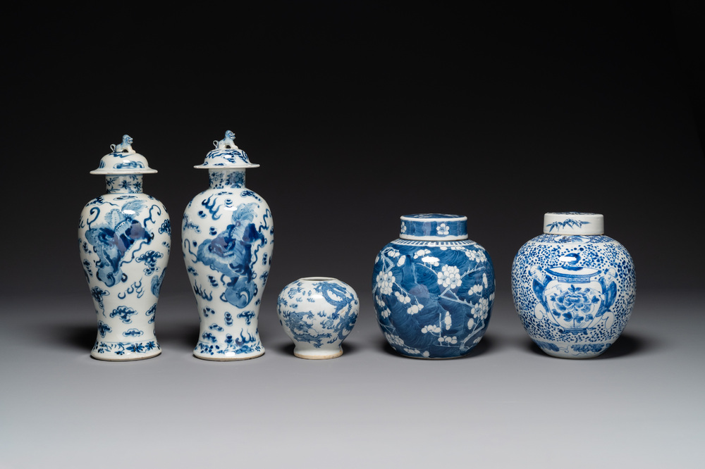 A pair of Chinese blue and white covered vases and three jars, 19th C.