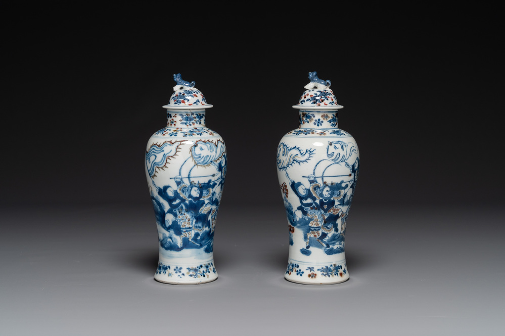 A pair of Chinese blue, white and copper-red vases and covers, Kangxi mark, 19th C.