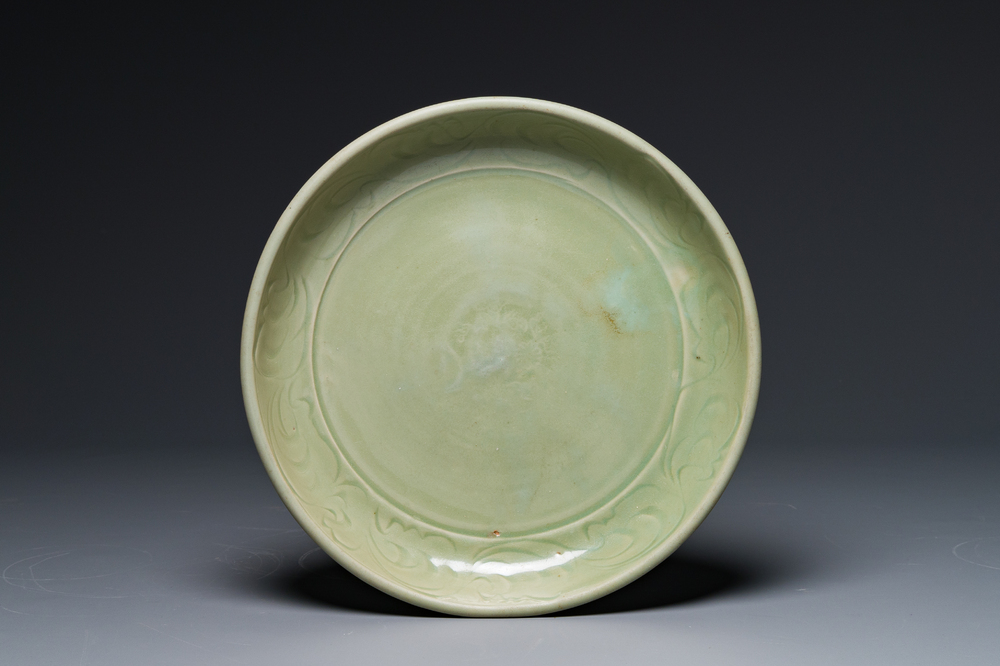 A Chinese Longquan celadon dish with floral anhua design, Ming