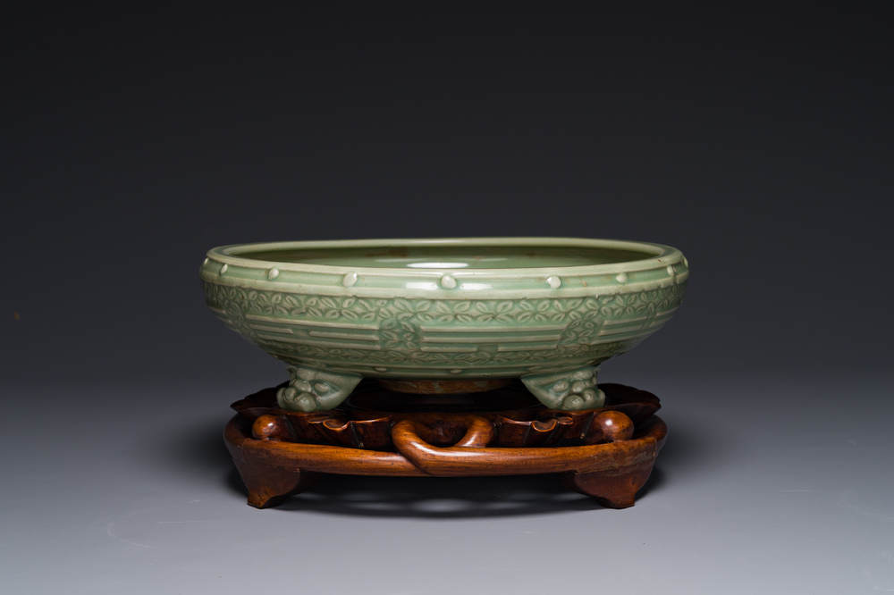 A large Chinese Longquan celadon 'trigrams' censer on wooden stand, Ming