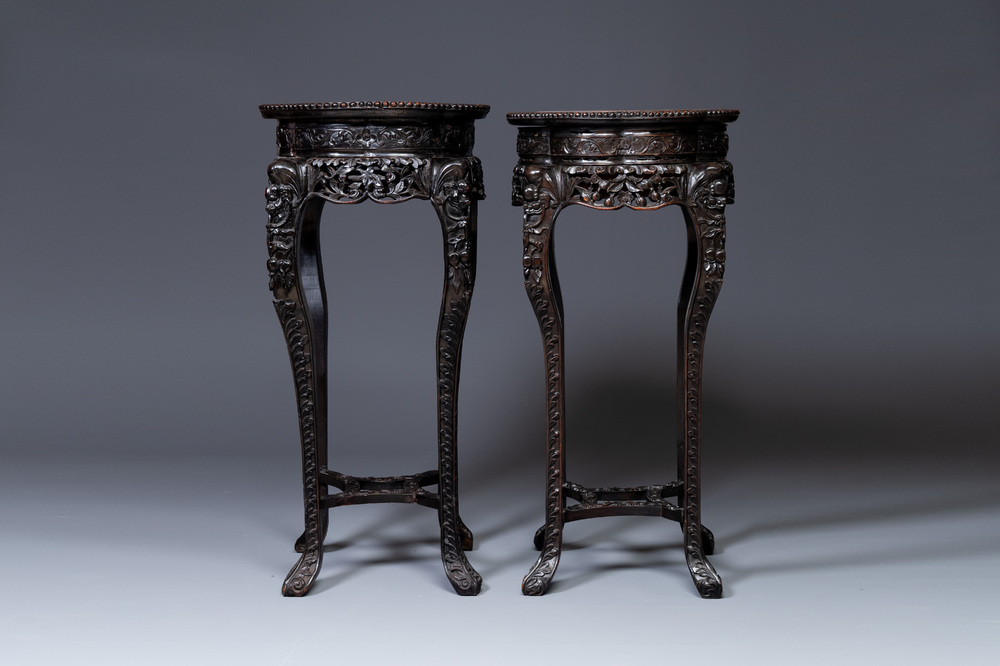 A pair of tall Chinese carved wooden stands with marble tops, 19th C.