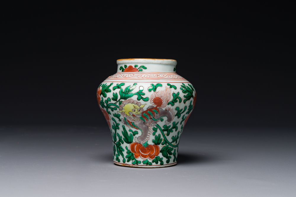 A small Chinese wucai 'Buddhist lion and peony scroll' jar, Transitional period