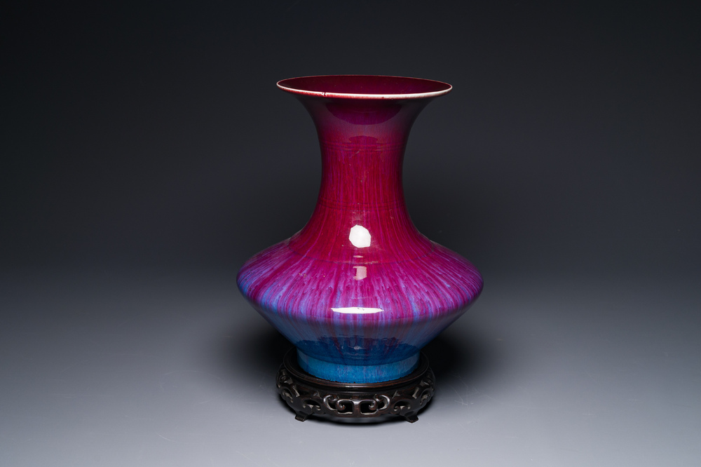 A Chinese flamb&eacute;-glazed vase on a wooden stand, 19th C.