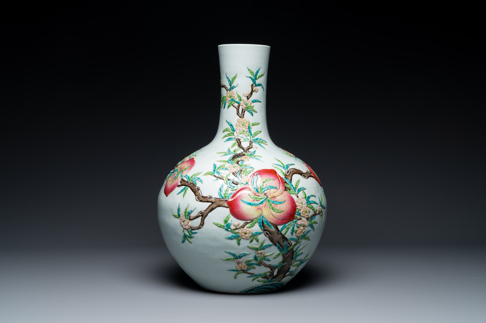 A Chinese famille rose relief-molded 'tianqiuping' vase with nine peaches, Qianlong mark, 19/20th C.