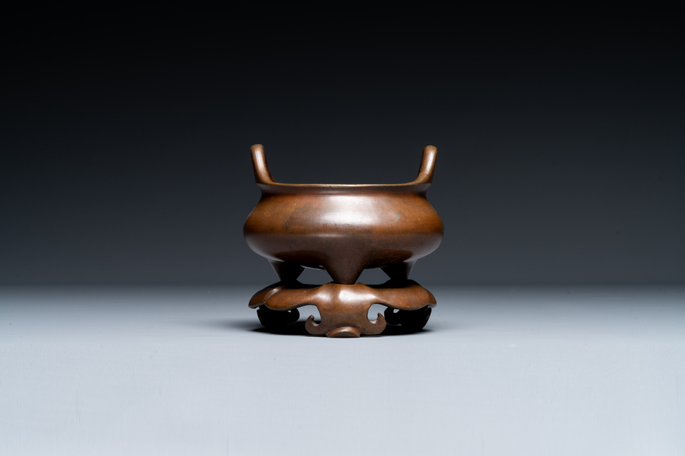 A Chinese bronze tripod censer on a stand, Xuande mark, 19th C.