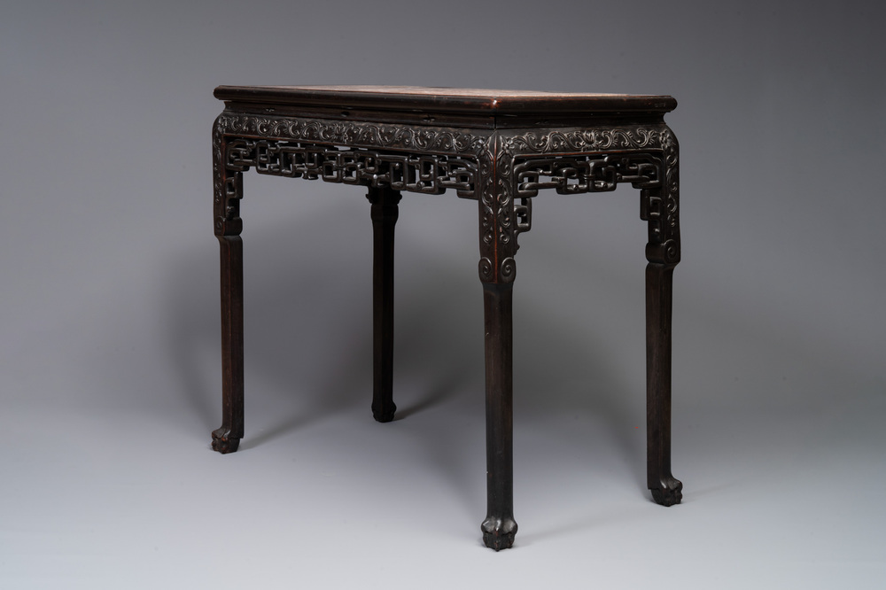 A rectangular Chinese carved wooden console table with a pink marble top, 19th C.