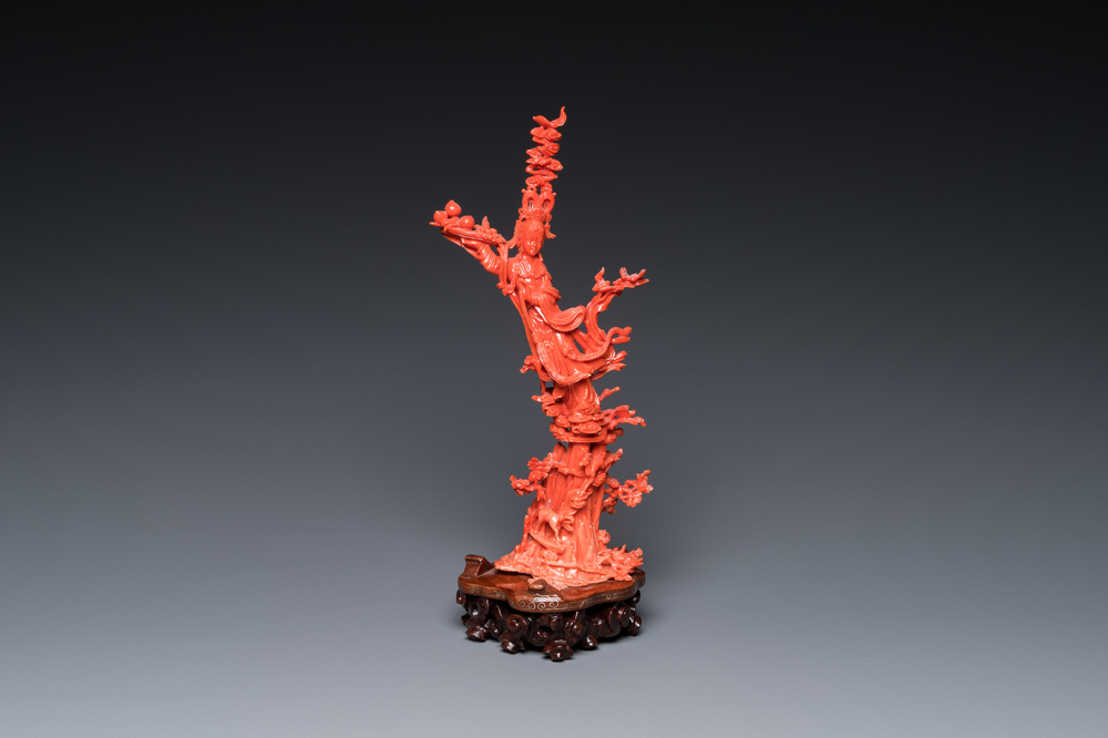 A Chinese red coral sculpture of Xiwangmu standing on a rock, 19/20th C.