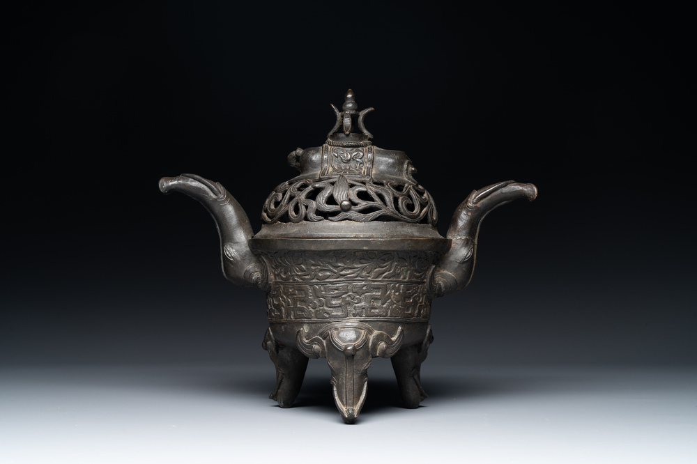 A Chinese bronze 'elephant' tripod censer and cover, Ming