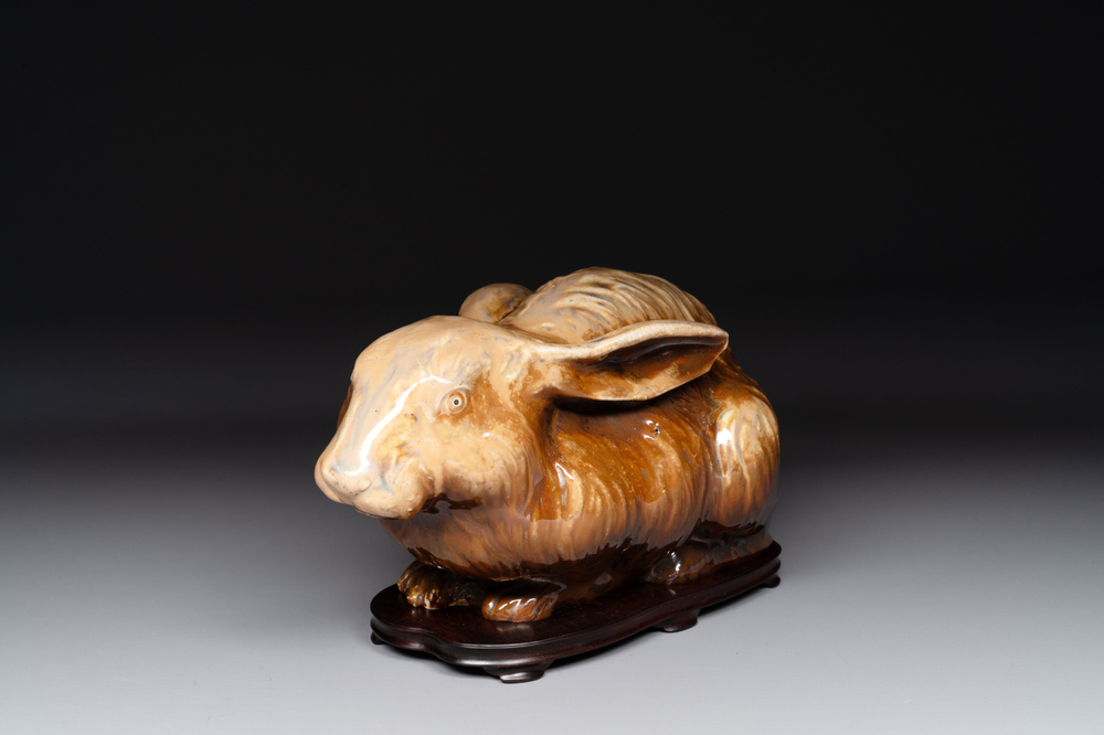 A fine Chinese cafe-au-lait glazed hare on wooden stand, Tian 天 mark, Qing