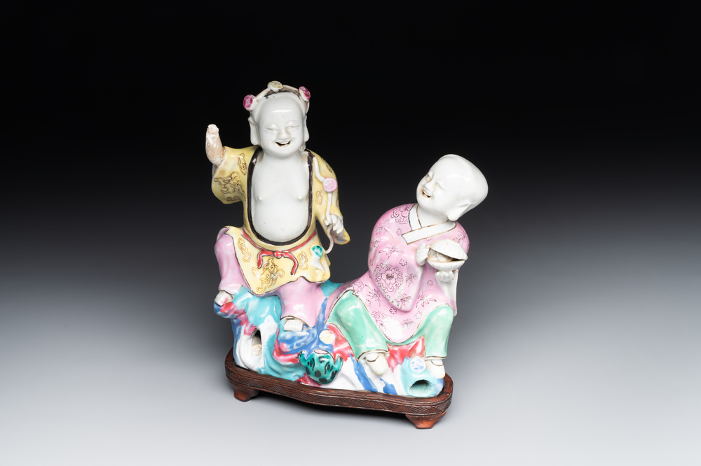 A Chinese famille rose group of Hehe Erxian on wooden stand, Qianlong