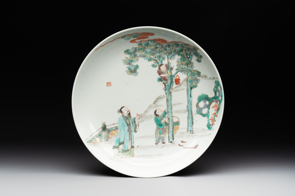 A Chinese famille verte dish with a sage and two boys under a tree, Shizhu 石竹 seal mark, Yongzheng