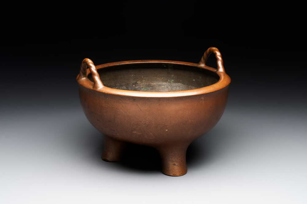 A large Chinese bronze tripod censer with two handles, 19th C.